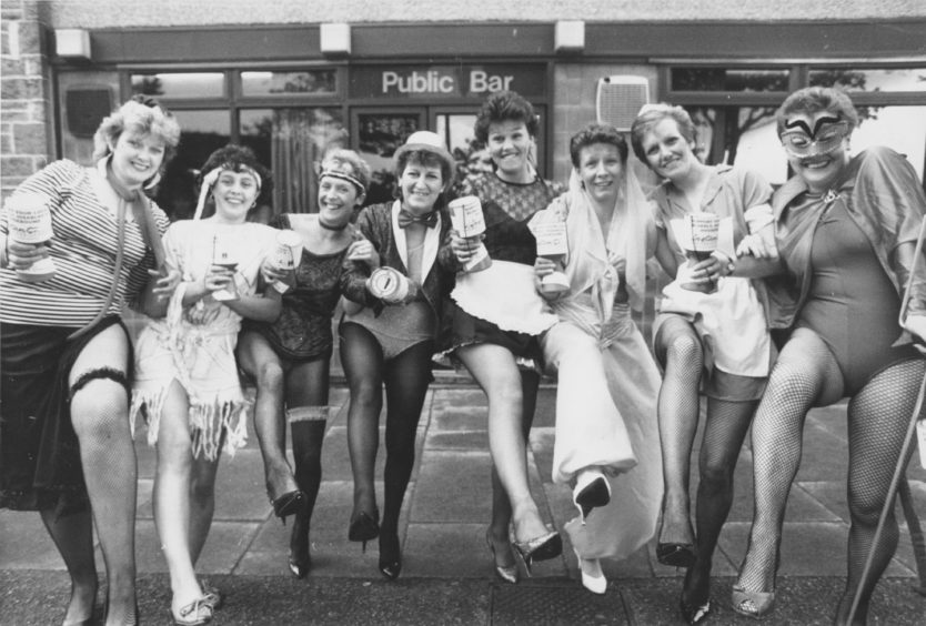 1988: Shaking a leg, and a collecting tin, during a marathon fancy dress pub crawl collection on Saturday are eight mothers of pupils at Victoria Road Primary in Torry.