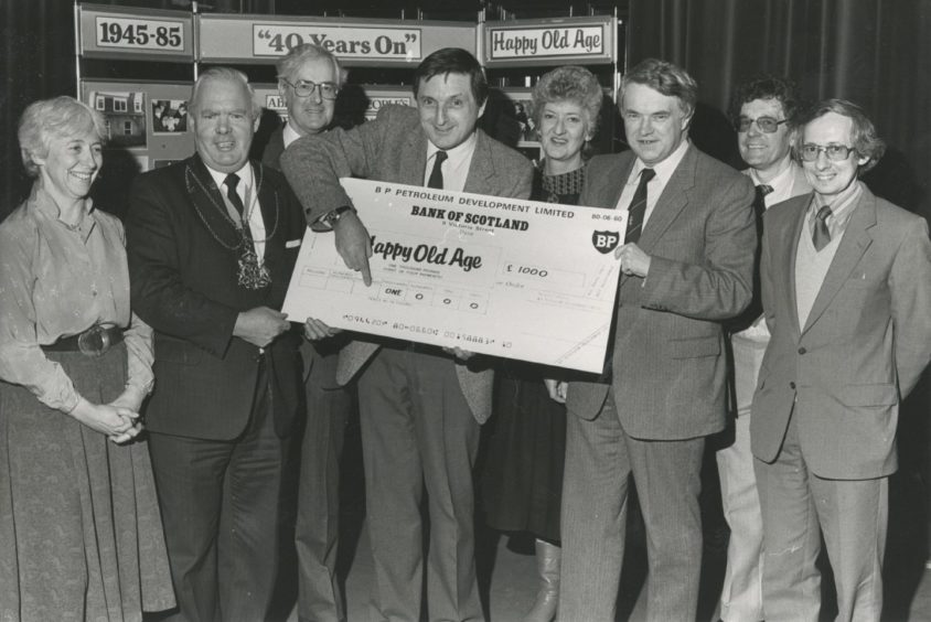 1985: As Buff Hardie of Scotland the What? points out, it's another £1000 for the Happy Old Age Appeal of the Voluntary Service Aberdeen. And helping hold up the big donation from BP are (left) Lord Provost Henry Rae and BP acting assistant  general manager (administration) Mr David Jamieson. Also pictured at the presentation at the VSA's annual meeting yesterday are Mrs Jean Drey, VSA chairman Mr Colin Murray, BP's Sheila Black, appeals assistant Mr John Thwaites and Aberdeen Old People's Welfare Council secretary Mr Bill Howie.