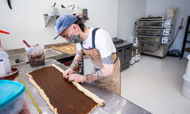 Pete Leonard prepares cinnamon buns for another busy day ahead at Bandit Bakery in Rose Street, Aberdeen.