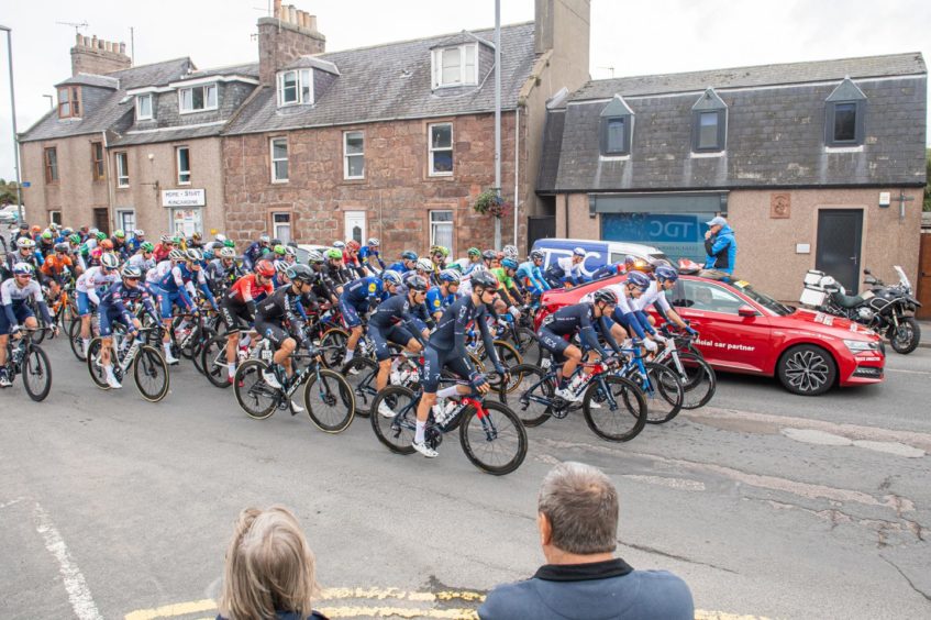 The cyclist procession heads through Stonehaven streets.