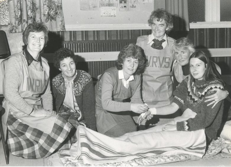 1982: Ellon WRVS rehearse emergency first-aid during an excuse yesterday which simulated a dangerous chemicals spillage in the town. Giving treatment to "injured" patient Mrs Kate Ferries is Mrs Eunice Thomson, a former nurse. Also pictured are (left to right) Mrs Doreen Davidson; Mrs Elizabeth Watson; Mrs Elizabeth Watson; Mrs Millie Cook, WRVS emergency services organiser for Gordon, and Mrs Patricia Towsey.