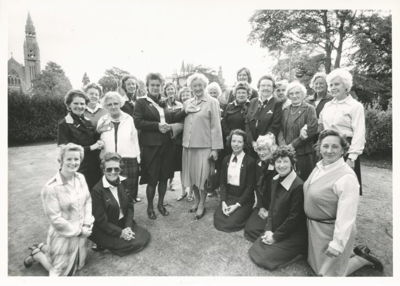 1983: Two long-serving members of the WRVS receive awards for their service during the Grampian regional meeting at their headquarters in Queen's Gardens, Aberdeen, yesterday. Regional organiser Muriel Scanlan (middle row, third left) makes the presentation to Mrs Gladys Leiper (fourth left), who has served 15 years at Woolmanhill canteen, as deputy regional organiser Joan Rafferty (middle row, left) hands over a medal to Mrs Mary Cattanach (second left), to commemorate her 17 years in processing clothing. Other WRVS members look on.