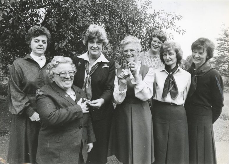 1985: Aberdeenshire Miss Alma Pawson (second left) receives a clasp from regional organiser of the WRVS Mrs Muriel Scanlon to mark her 27 years' work for the organisation. Miss Pawson (69) (second left), Flower Cottage, Braemar, received her award alongside Mrs Joe Dick (centre), 7 The Square, Tarland, who has given 25 years service. Looking on left to right are: Mrs Kathleen Marnoch, acting district organiser, Kincardine and Deeside; her secretary Mrs Anne Simpson; Mrs Mona Harcus, food organiser and Mrs Allison Gray, old peoples' welfare organiser, both Grampian Region.