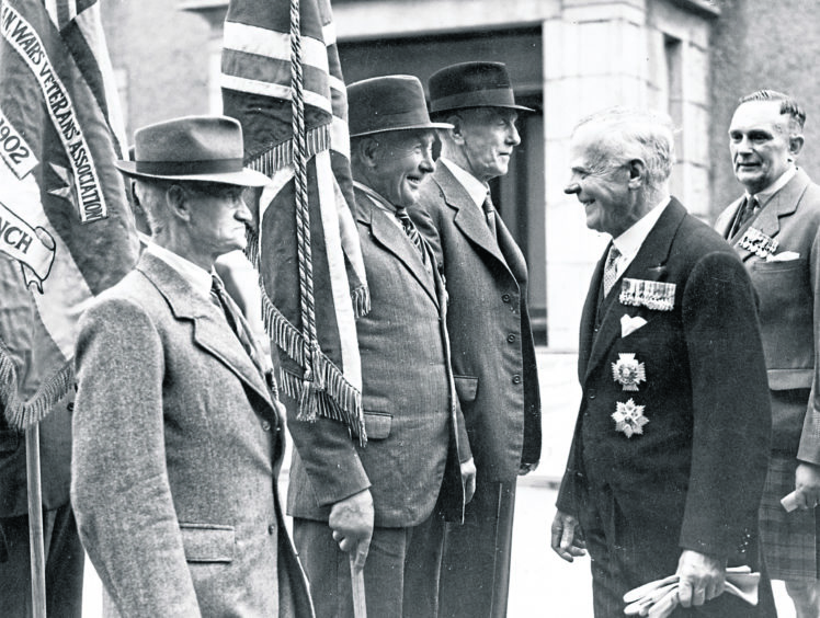 1948: Admiral Sir Lionel Wells K.C.B., D.S.O., inspecting the standard bearers at the British Legion Drumhead Commemoration Service at Hazlehead on Sunday.