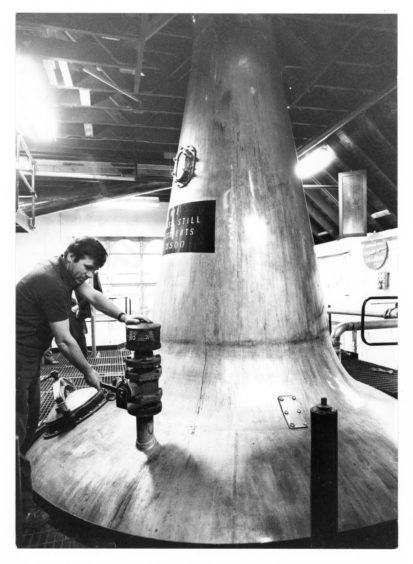 1979: Denis Kessack opens the air valve to discharge the still at Glen Garioch Distillery
