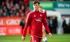 ABERDEEN, SCOTLAND - AUGUST 12 : Aberdeen's Calvin Ramsay warms up during a UEFA Conference League Qualifier 2nd Leg between Aberdeen and Breidablik at Pittodrie , on August 12, 2021, in Aberdeen, Scotland. (Photo by Ross Parker / SNS Group)