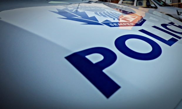 The front of a police vehicle with the word Police written in blue on a white background.