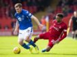 St Johnstone's Anthony Ralston (left) is tackled by Aberdeen's Funso Ojo.