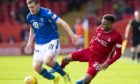 St Johnstone's Anthony Ralston (left) is tackled by Aberdeen's Funso Ojo.