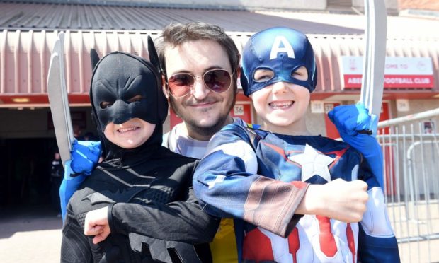 Myles Crombie, Andy Tilney and Logan Crombie enjoy Comic-Con at Pittodrie Stadium in Aberdeen in 2018.