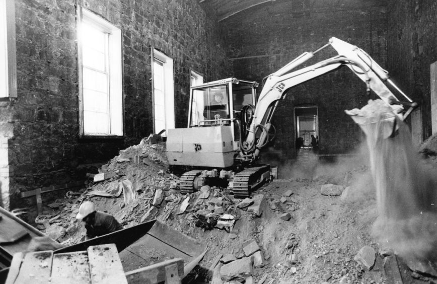 1985: The small ballroom of the Music Hall stripped bare and a digger hard at work during the 1985 refurbishment