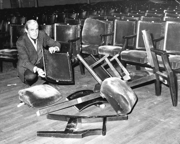 1985: D: Hallkeeper Ted Burnett looks at damage caused in the Music Hall after a gig by The Clash