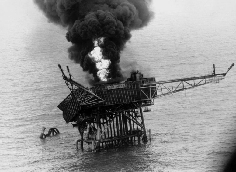 Flame and smoke rise from the Piper Alpha platform