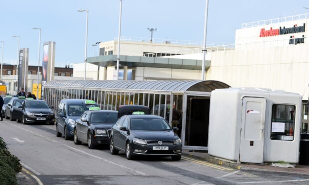Taxis queuing up at Aberdeen Airport. Image: Chris Cromar / DC Thomson.