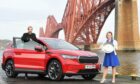 ASMW President Jack McKeown with Scottish Car of the Year, the Skoda Enyaq, and head of marketing for Skoda UK, Kirsten Stagg. Picture by Stuart Vance.