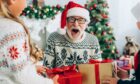 Old man receiving unique Scottish Christmas gifts