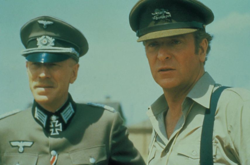 Max Von Sydow and Michael Caine agree to a friendly match between the Allies and an all-star Nazi XI.