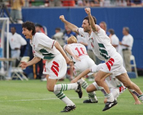 Bulgarian soccer players, from left: Daniel Borimirov, Ilian Kiriakov (16), Petra Houbtchev (5 partly hidden) and Hristo Stoitchkov (8) celebrate after Irodan Letchkov, unseen, scored the winning goal against Mexico in a penalty shootout during the second round World Cup soccer match at Giants Stadium, East Rutherford, New Jersey.