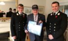 George Gordon receiving his framed print and cap
