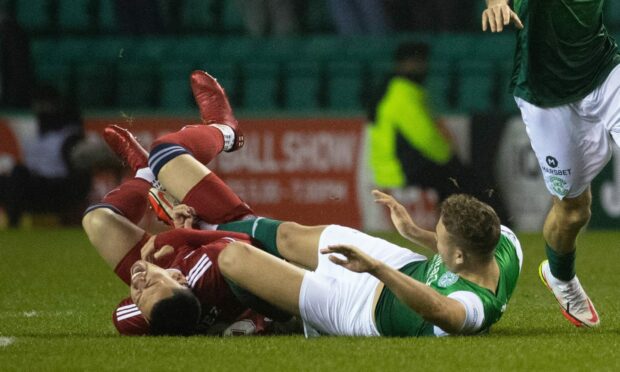 Ryan Porteous tangles with Aberdeen's Christian Ramirez at Easter Road in midweek.