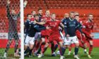 Aberdeen and Dundee players jostle for position at Pittodrie