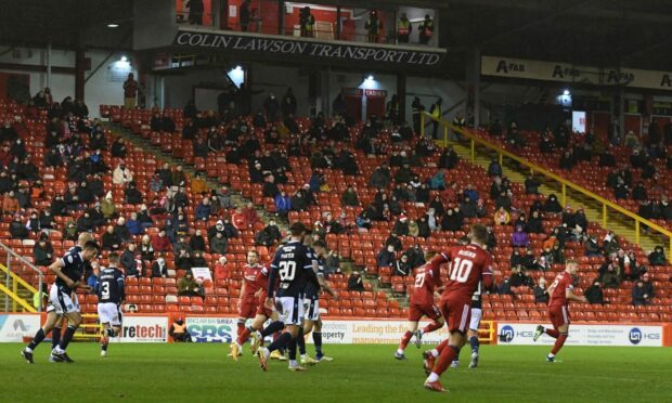 A small number of Aberdeen fans watch the 2-1 defeat of Dundee due to Covid-19 restrictions.