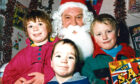 1990 - Diane Henderson, 10, her brother Christopher, 4, and Shaun Cowie, 7, pay a visit to Santa