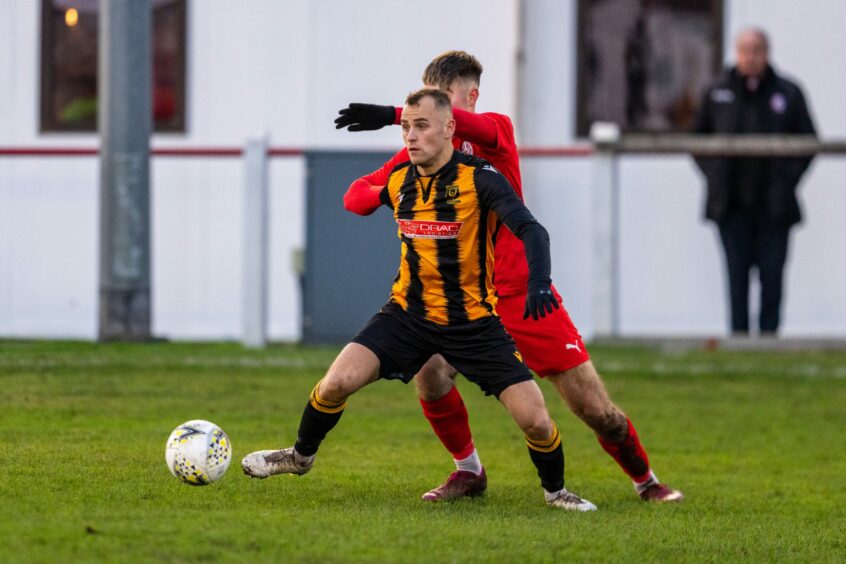 Huntly's Greg Buchan tries to keep possession