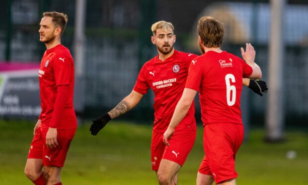 Brora's Jordan MacRae celebrates his hat-trick