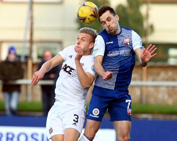 Harry Milne challenges Graham Webster during Cove Rangers' game with Montrose