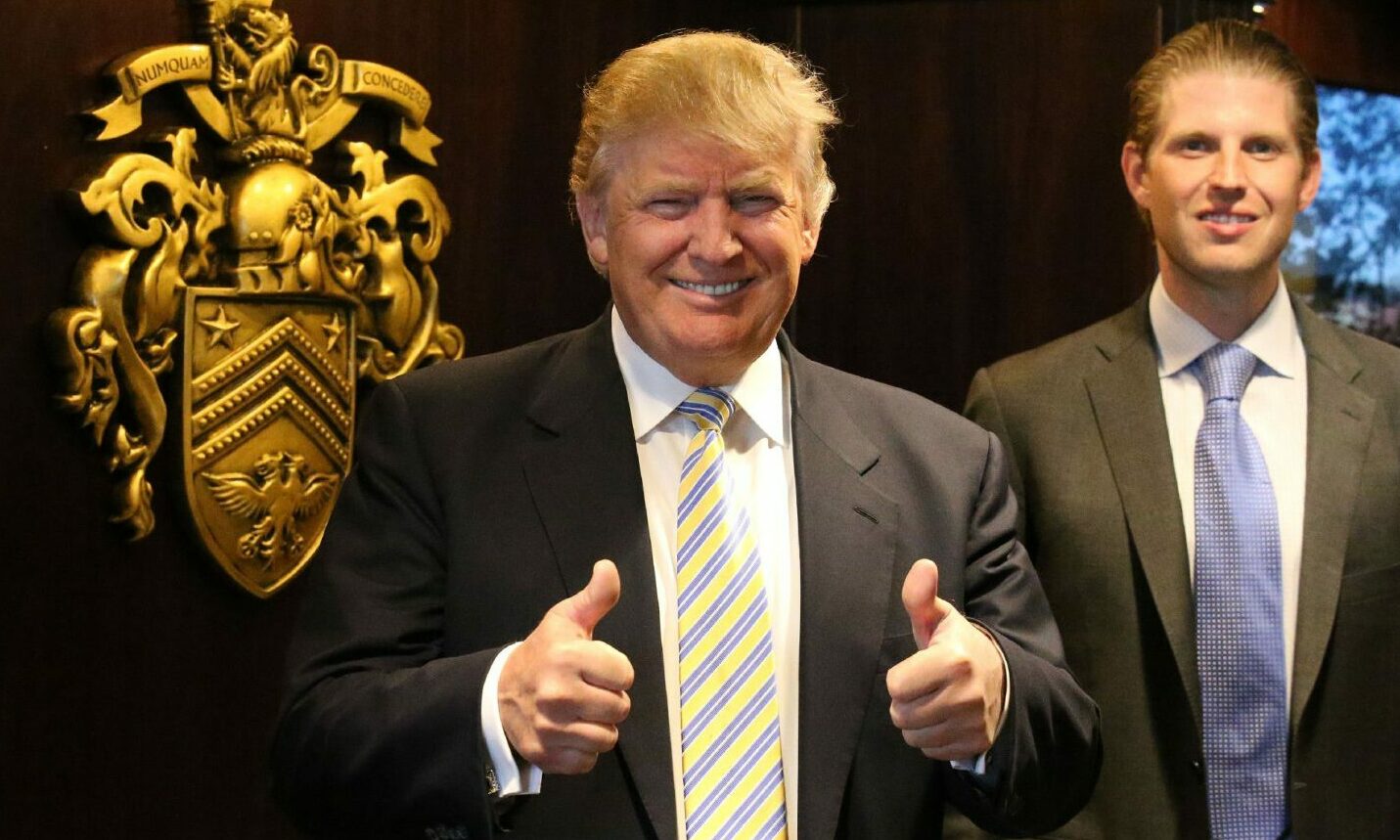 Donald Trump and his son Eric with the family crest after unveiling the multi-million pound refurbishment of the Trump Turnberry clubhouse.