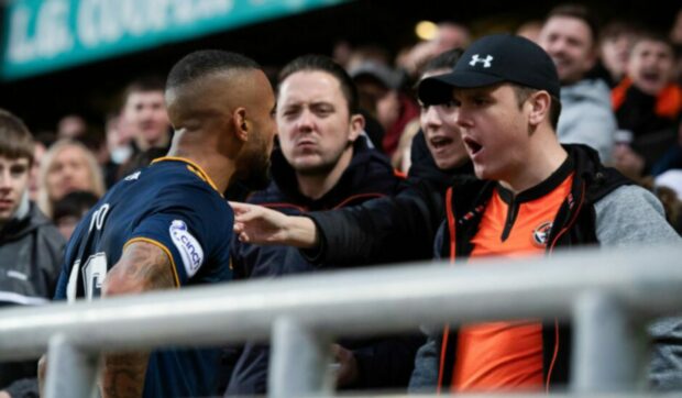 Dundee United fan Marc Jackson, right with black cap, assaulted Aberdeen's Funso Ojo during this pitch-side confrontation
