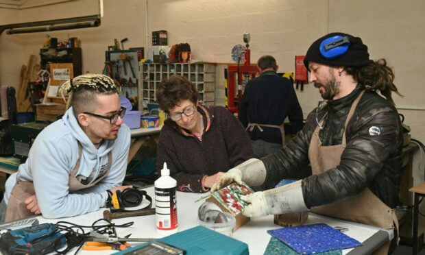 Sola Ogunyemi, Gillian Cummins and Andy MacVicar making a birdhouse at a Green Hive workshop.  Picture: Jason Hedges/DCT Media