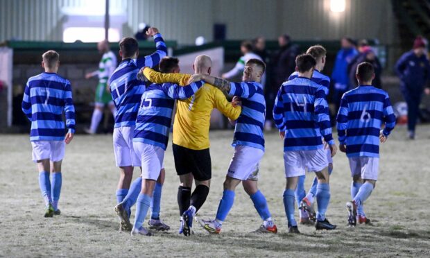 The Banks o' Dee players celebrate after their penalty shoot-out win against Buckie Thistle in the Aberdeenshire Shield