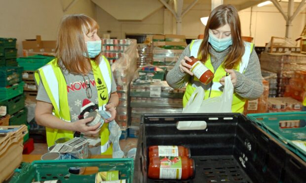 Press & Journal staff assist Cfine volunteers to make up food parcels for those in need (Photo: Kami Thomson/DCT Media)