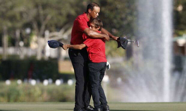Tiger Woods hugs son Charlie Woods on the 18th green after the second round of the PNC Championship.