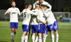 Fraser Fyvie is mobbed by Cove Rangers team-mates after scoring the opener