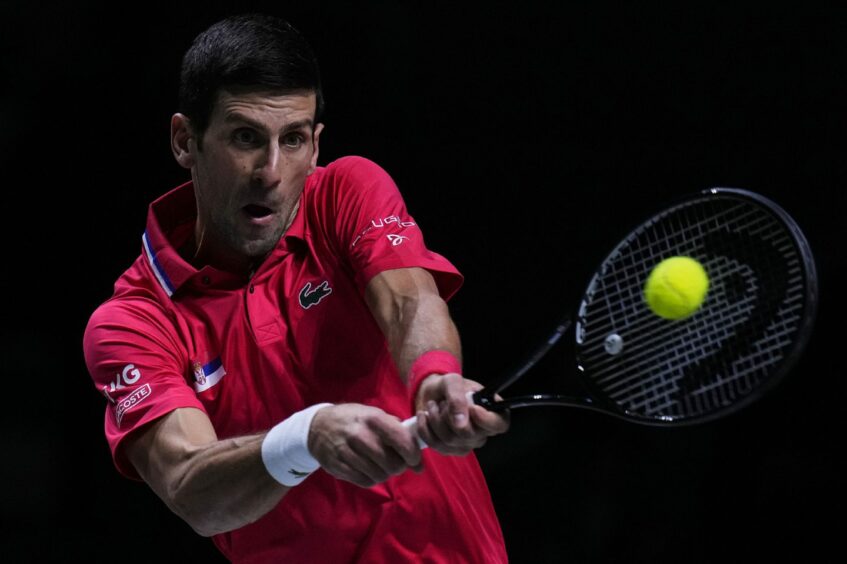Novak Djokovic hitting a tennis ball
