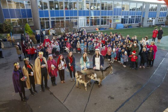 Children outside the school as the donkeys visit