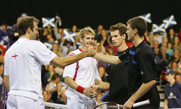 Scotland's Andy Murray (second right) and brother Jamie (right) shake hands after his double match against England's Greg Rusedski (left) and James Auckland in the Aberdeen Cup at the AECC Press and Journal Arena, Aberdeen. PRESS ASSOCIATION Photo. Picture date: Sunday November 26, 2006. Photo credit should read: Simon Price/PA.