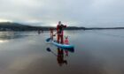 50 paddleboarders dressed as Santa went out on Loch Morlich despite it being partly-frozen. Picture by Emma McLeoud.