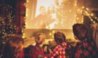 Family enjoying a Christmas movie night gift basket