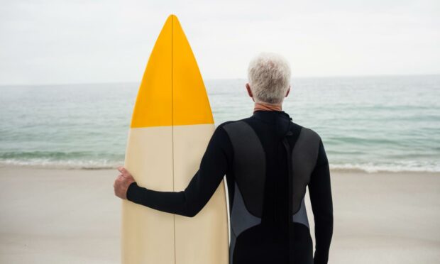 Over 50 and want to don a wetsuit and catch some waves? Go for it (Photo: wavebreakmedia/Shutterstock)