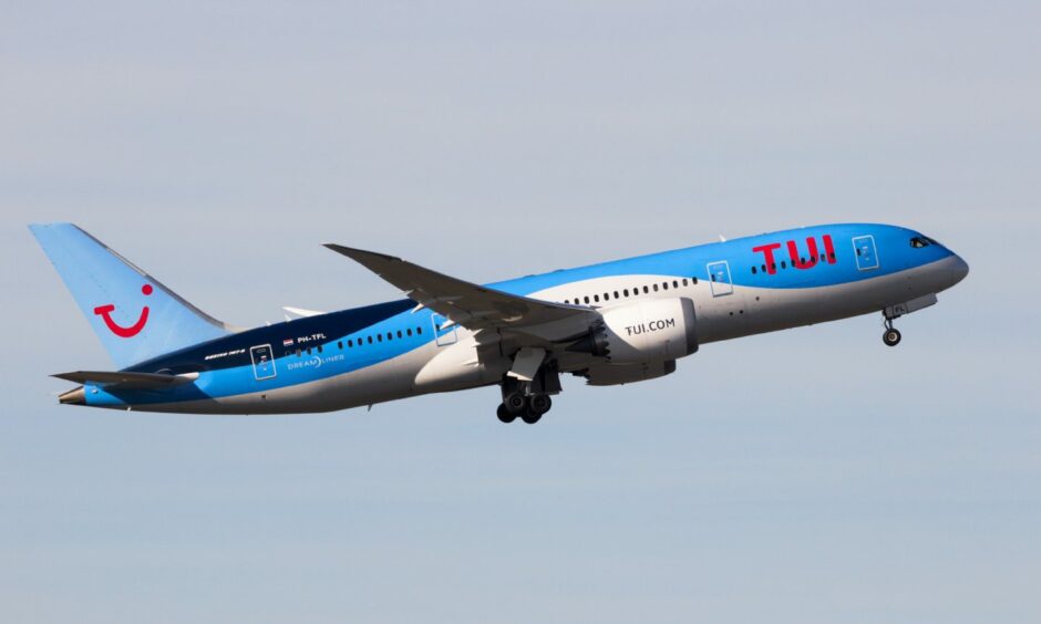 A Tui plane in the air
