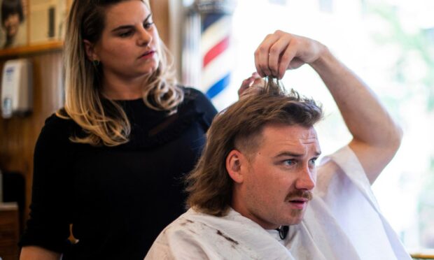 Country singer Morgan Wallen receives a mullet after seeing old photos of his dad proudly rocking the hairstyle (Photo: Charles Sykes/Invision/AP/Shutterstock)
