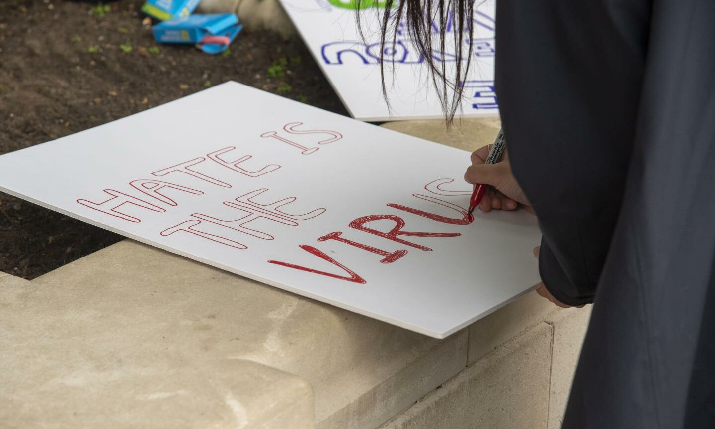 A demonstrator drawing a placard for a 'stop Asian hate' protest earlier this year (Photo: Dave Rushen/SOPA Images/Shutterstock)