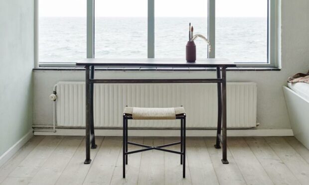 The stripped back simplicity of a Skagerak Vent Stool from Nest, a table and a view.