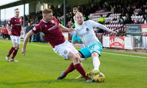 Arbroath's Jason Thomson (left) tackles Inverness' Tom Walsh at Gayfield.