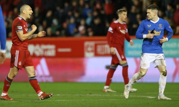 Rangers' Ryan Kent is sent off by referee Kevin Clancy and Scott Brown (left) speaks to him as he leaves the field.