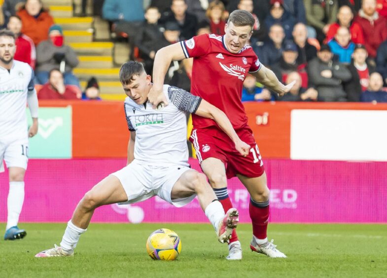 Aberdeen's Lewis Ferguson is challenged during the cup tie against Edinburgh City.